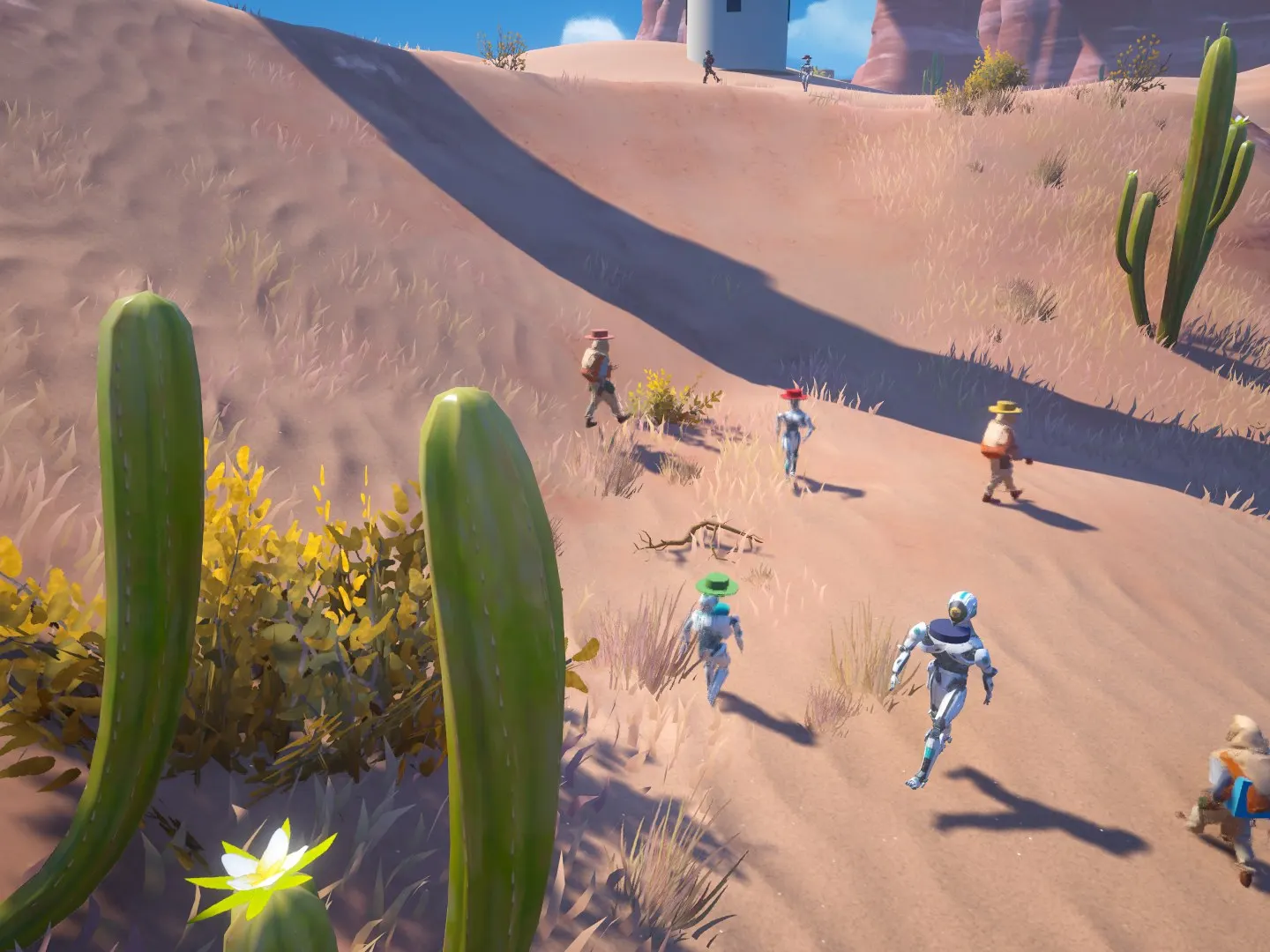 A group of original characters and droids walking across the sand past cacti